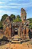 Angkor - Eastern Mebon - towered passageways leading to the first enclosure of the temple,  with stone lions guarding the entrance.